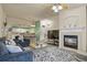 Open-concept living space featuring a fireplace and view of the kitchen with modern decor at 1404 Whitehall Dr # C, Longmont, CO 80504