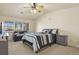Bright main bedroom with a ceiling fan, and a view of the lush neighborhood at 1404 Whitehall Dr # C, Longmont, CO 80504