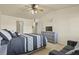 Spacious bedroom featuring neutral walls, gray furnishings, and a ceiling fan at 1404 Whitehall Dr # C, Longmont, CO 80504