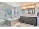 Bright bathroom featuring a large soaking tub, glass shower, and double sink vanity at 3343 W 109Th Cir, Westminster, CO 80031
