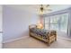 Bedroom featuring a bed, ceiling fan, and light purple walls with bright natural light at 3343 W 109Th Cir, Westminster, CO 80031