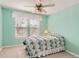 Bright bedroom with a colorful bedspread, neutral carpet and walls, with natural light coming through the windows at 3343 W 109Th Cir, Westminster, CO 80031
