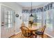 Cozy breakfast nook with a wooden table and chairs surrounded by three bright windows at 3343 W 109Th Cir, Westminster, CO 80031
