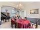 Formal dining room with a large crystal chandelier, piano, and a view of the staircase at 3343 W 109Th Cir, Westminster, CO 80031