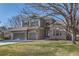 Charming two-story brick home featuring a three-car garage and well-manicured front lawn at 3343 W 109Th Cir, Westminster, CO 80031