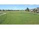 A well-manicured green on a golf course, showcasing the beautiful landscaping and open space at 3343 W 109Th Cir, Westminster, CO 80031