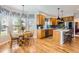 Open kitchen with stainless appliances, breakfast nook, and hardwood floors throughout at 3343 W 109Th Cir, Westminster, CO 80031