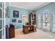 Well-lit home office with a large desk, built-in shelving, and plenty of natural light from the large window at 3343 W 109Th Cir, Westminster, CO 80031