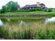Scenic view of a pond with lush landscaping, reflecting the natural beauty of the community at 3343 W 109Th Cir, Westminster, CO 80031