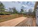 A wooden deck in the backyard with a railing and access to the lawn at 1758 S Ensenada St, Aurora, CO 80017