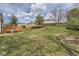 View of the backyard, which features a lawn, trees, and a wooden deck at 1758 S Ensenada St, Aurora, CO 80017