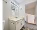 Well-lit bathroom features a single sink vanity, mirror, and neutral wall color at 1758 S Ensenada St, Aurora, CO 80017