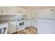Functional kitchen with white appliances, cabinets, and wood-look flooring at 1758 S Ensenada St, Aurora, CO 80017