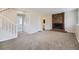 Cozy living room with a brick fireplace, stairway, and access to bathroom at 1758 S Ensenada St, Aurora, CO 80017