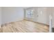 Bright and airy living room featuring hardwood floors, a large window, and a white front door at 1758 S Ensenada St, Aurora, CO 80017