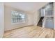 Spacious living area with light hardwood floors, large window, and staircase to the upper level at 1758 S Ensenada St, Aurora, CO 80017