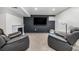 Finished basement boasts a cozy seating area with a fireplace and a large-screen television at 2650 S Vaughn Way # D, Aurora, CO 80014