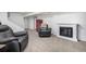 Finished basement features cozy seating area with fireplace and stairs leading to upper level at 2650 S Vaughn Way # D, Aurora, CO 80014