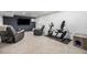 Spacious basement with comfortable recliners, television, and workout equipment at 2650 S Vaughn Way # D, Aurora, CO 80014