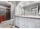 Bright bathroom with double sinks, shower, and tile flooring at 2650 S Vaughn Way # D, Aurora, CO 80014