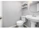 Cozy powder room featuring pedestal sink, modern fixtures, and neutral decor at 2650 S Vaughn Way # D, Aurora, CO 80014