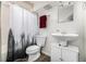 Clean bathroom featuring a shower with curtain, toilet, and pedestal sink at 2650 S Vaughn Way # D, Aurora, CO 80014