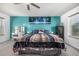 Bright bedroom features a large bed, a vanity with decor, and a ceiling fan at 2650 S Vaughn Way # D, Aurora, CO 80014