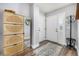 Cozy entryway features wood-look floors, decorative cabinet, mirror and coat rack at 2650 S Vaughn Way # D, Aurora, CO 80014