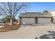 Exterior shot of two-car garages with stone accents and large driveways at 2650 S Vaughn Way # D, Aurora, CO 80014