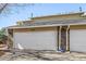 Paired home with attached one-car garage featuring stone accents and neutral siding at 2650 S Vaughn Way # D, Aurora, CO 80014