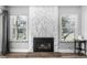 Bright living room features a white stone fireplace, wood floors and large windows at 2650 S Vaughn Way # D, Aurora, CO 80014