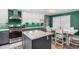 Eat-in kitchen features a center island, stainless appliances, a breakfast table, and modern lighting at 2650 S Vaughn Way # D, Aurora, CO 80014