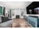 Bright and airy living room with fireplace, wood floors, console, and large windows at 2650 S Vaughn Way # D, Aurora, CO 80014
