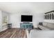 Comfortable living room with window, large couch, wood floors, and entertainment center at 2650 S Vaughn Way # D, Aurora, CO 80014