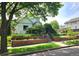 Charming home showcasing a well-manicured lawn and flower beds with mature trees at 2809 Yates St, Denver, CO 80212