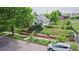 Charming home featuring a well-manicured lawn, flower beds, mature trees, and a quaint facade at 2809 Yates St, Denver, CO 80212