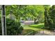Serene front yard view featuring mature trees, lush lawn, and charming neighborhood street at 2809 Yates St, Denver, CO 80212