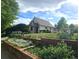 Charming house with a well-manicured front yard featuring flowers, garden beds, and lush greenery at 2809 Yates St, Denver, CO 80212