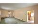 Bright living room with neutral walls, carpet flooring, and an ornate entry door at 2809 Yates St, Denver, CO 80212