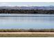Scenic view of Sloan's Lake with distant snow-capped mountains and lush greenery along the shoreline at 2809 Yates St, Denver, CO 80212