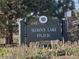 Sign to Sloan's Lake Park features decorative posts, a mesh background, and lettering with natural plants in front at 2809 Yates St, Denver, CO 80212