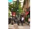 A vibrant street scene with pedestrians, cyclists, and shops under the green traffic light at 2809 Yates St, Denver, CO 80212