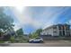 Street view of a luxurious property with a white SUV parked in front of its manicured lawn and elegant facade at 2809 Yates St, Denver, CO 80212