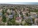 Aerial view of a landscaped neighborhood and home with mature trees at 742 Norwich Ct, Castle Pines, CO 80108