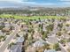 A picturesque aerial view showcasing a well-maintained neighborhood with mature trees and golf course in the background at 742 Norwich Ct, Castle Pines, CO 80108