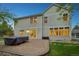 A lovely backyard features a charming patio, complemented by manicured green grass and bright windows at 742 Norwich Ct, Castle Pines, CO 80108