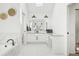 Well-lit bathroom showcasing a soaking tub and a vanity with double sinks and overhead lighting at 742 Norwich Ct, Castle Pines, CO 80108