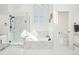 Modern bathroom featuring a glass shower, white tub, and window for natural light at 742 Norwich Ct, Castle Pines, CO 80108