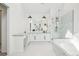 Bright bathroom featuring a glass shower, soaking tub, and a vanity with double sinks at 742 Norwich Ct, Castle Pines, CO 80108