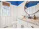 Charming powder room with board and batten walls, granite countertops, and round mirror at 742 Norwich Ct, Castle Pines, CO 80108